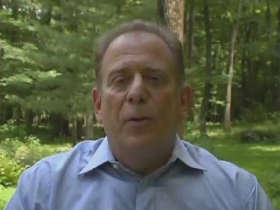 Middle-aged man speaking outdoors in backyard