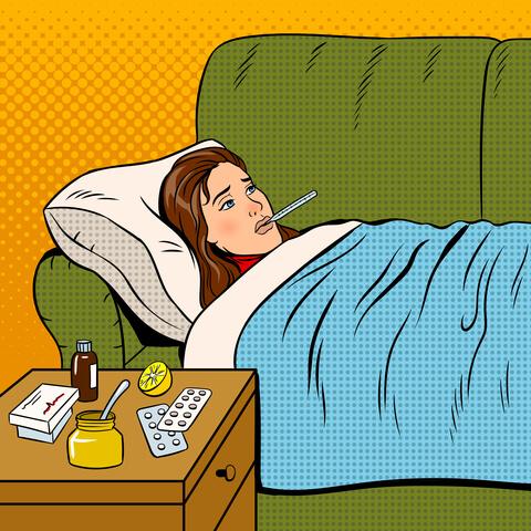 Woman lying sick on couch with thermometer