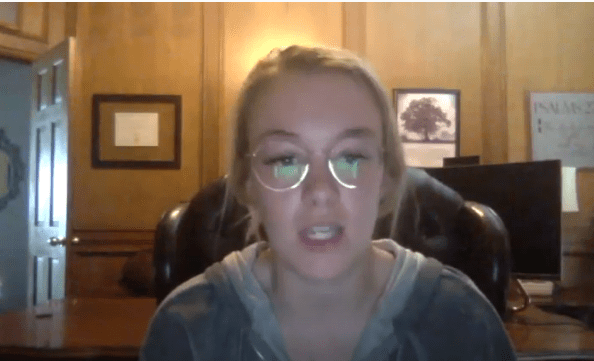 Person wearing glasses speaking in home office