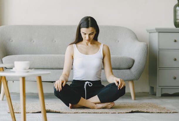 a woman practicing nose breathing at home
