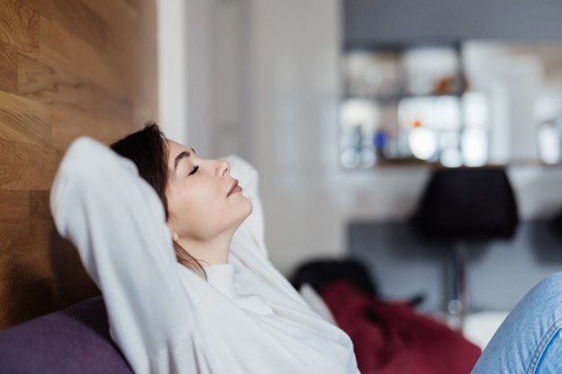 Relaxed woman reclining on couch at home