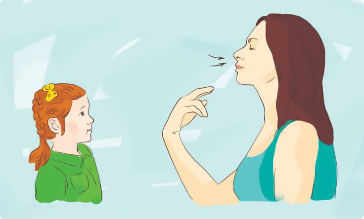 Woman teaching child breathing exercise
