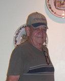 Man wearing cap and glasses indoors