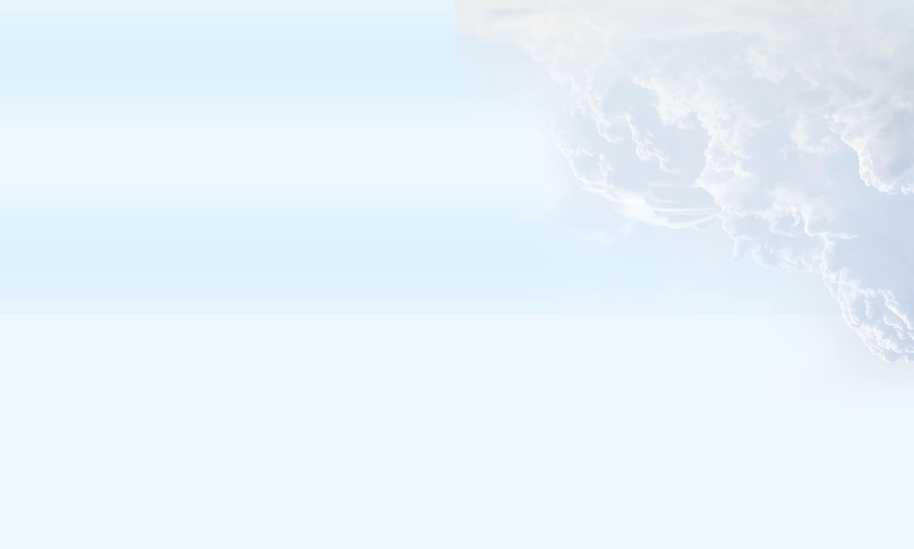 Light blue sky with soft white clouds