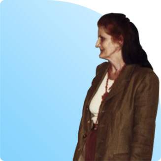 Woman in brown blazer standing in profile