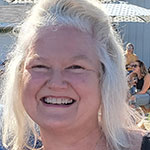 Smiling woman with long light hair outdoors