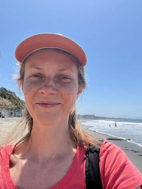 Smiling person taking selfie on sunny beach