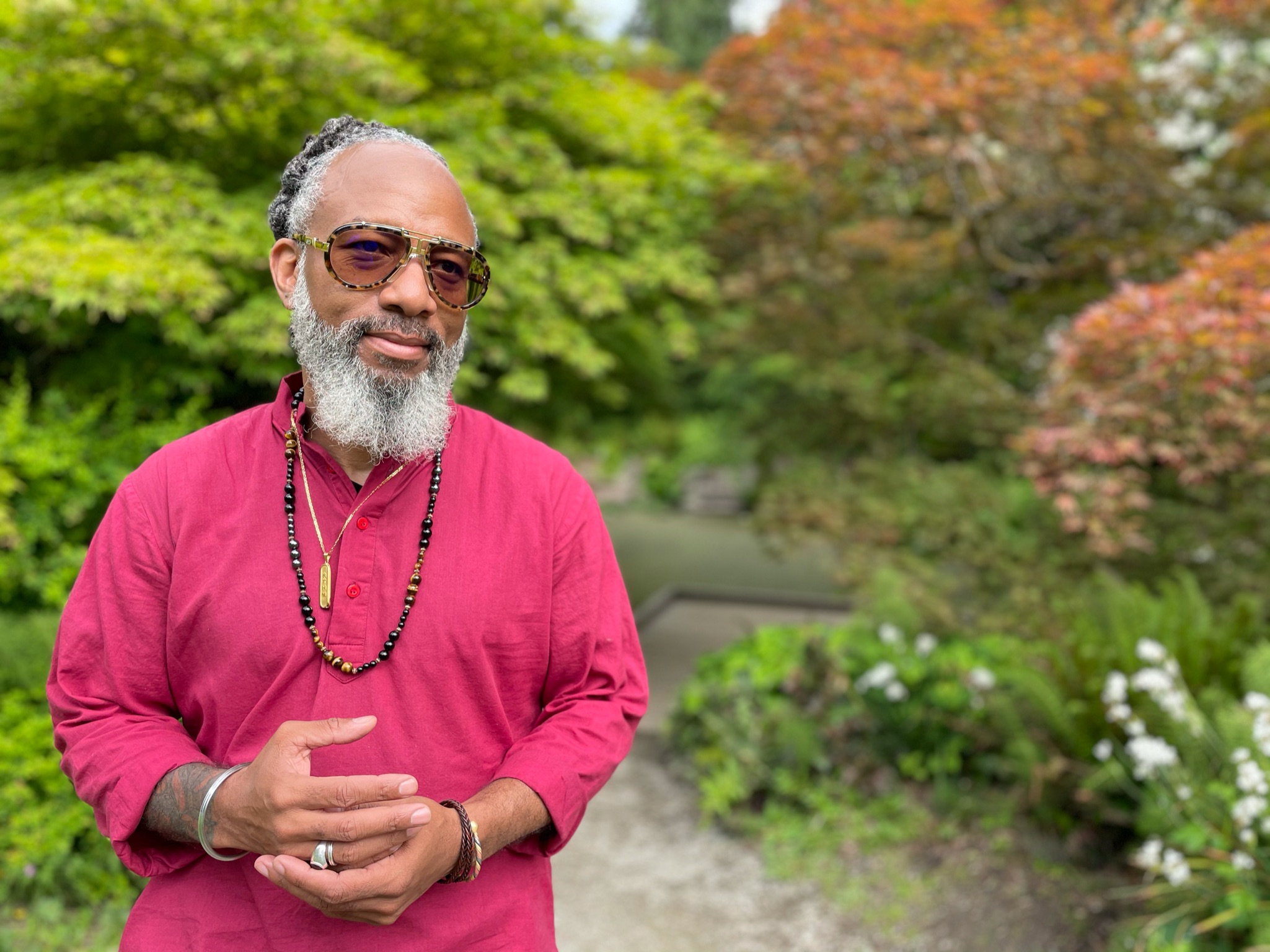 Bearded person with sunglasses in garden